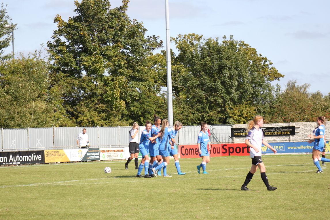 players celebrate after scoring goal at Derby