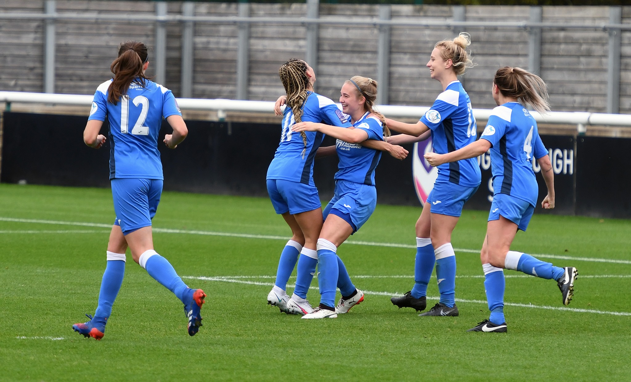 Players celebrate with Cooper after she scores